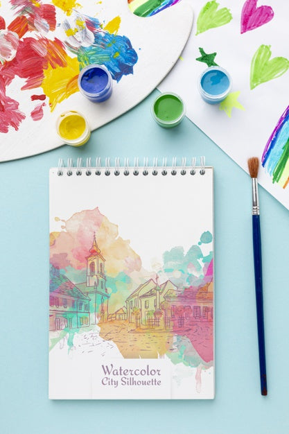 Free Notebook With Watercolors On Table Psd