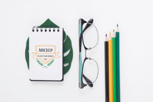 Free Notepad Mock-Up Next To Stationery Elements Psd