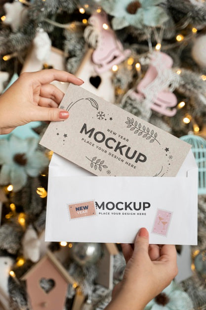 Free Person Holding Card With Envelope Next To Christmas Decorations Psd