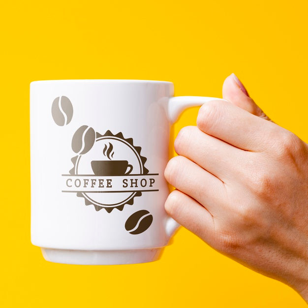 Free Person Holding Mug Mock-Up Psd