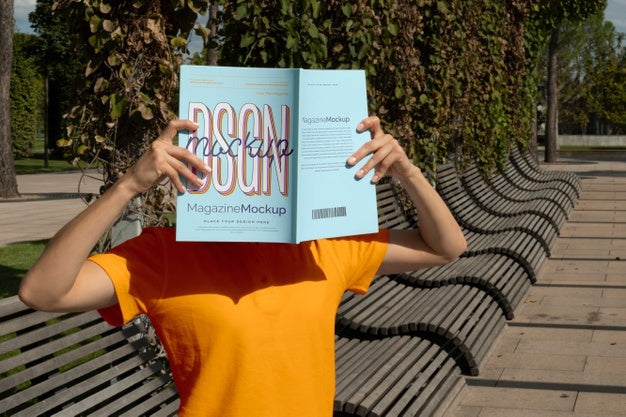 Free Person Reading Color Pop Magazine With Cover Mockup Psd