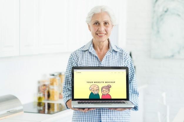 Free Senior Woman Holding Laptop Mockup Psd