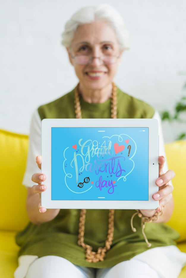 Free Senior Woman Holding Tablet Mockup Psd