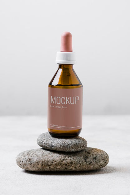 Free Serum Bottle On Rocks Stack Psd