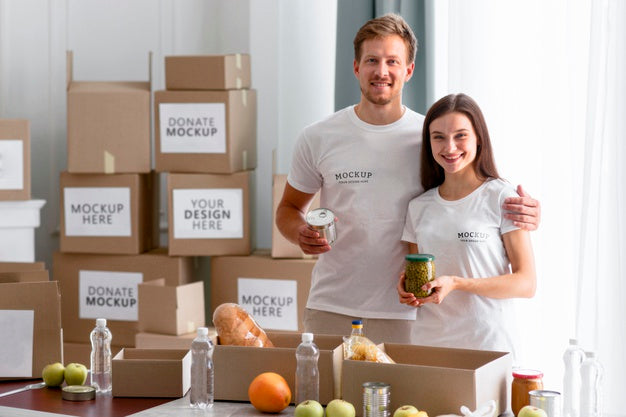 Free Smiley Volunteers Posing Together While Preparing Boxes Of Provisions For Donations Psd