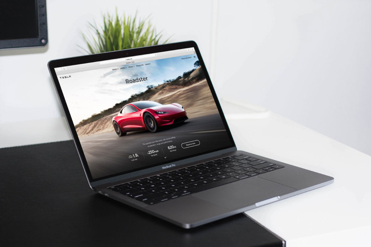 Free Space Gray Macbook on A Table PSD Mockup