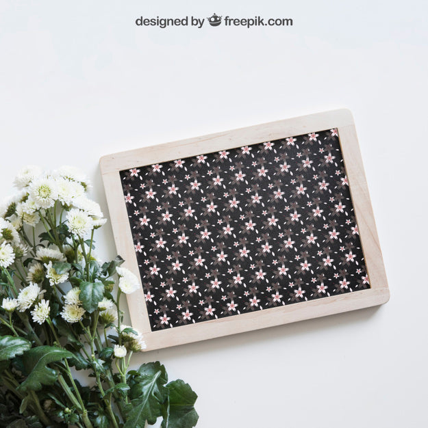 Free Spring Mockup With Slate Next To Wildflowers Psd