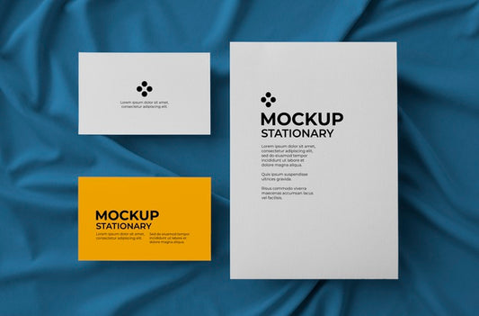 Free Stationary With Big Card And Two Bussiness Cards Over Fabric Background Mockup Psd
