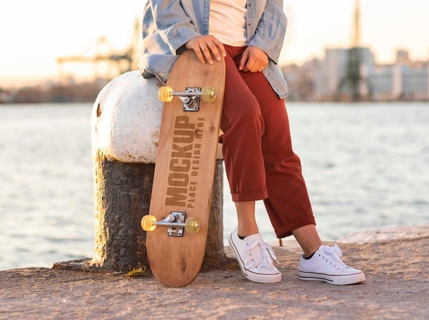 Free Teenager With Mock-Up Skateboard At The Pier Psd