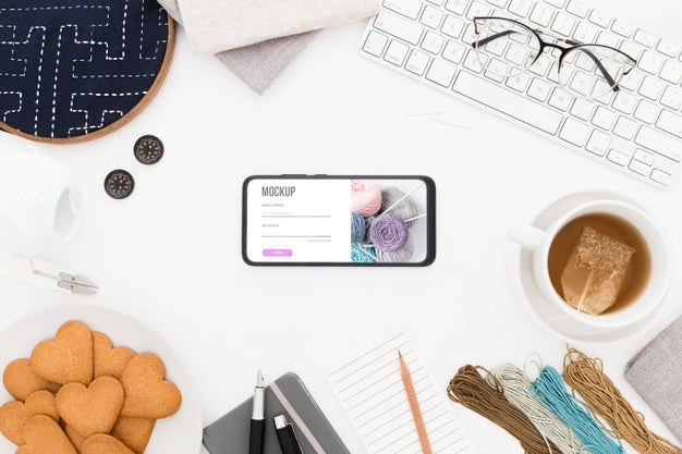 Free Top View Desk With Cookies And Phone Mock-Up Psd