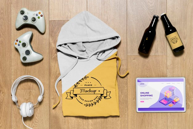 Free Top View Folded Hoodie Mock-Up With Gadgets And Bottles Psd