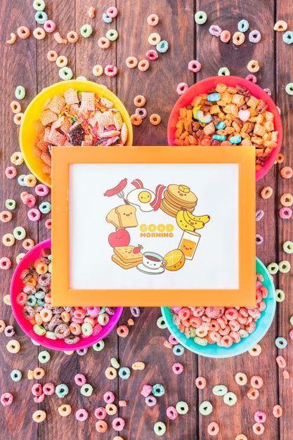 Free Top View Of Colorful Ceareals With Frame Mockup On Wooden Table Psd