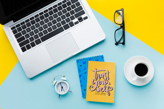 Free Top View Of Desk With Laptop And Clock Psd