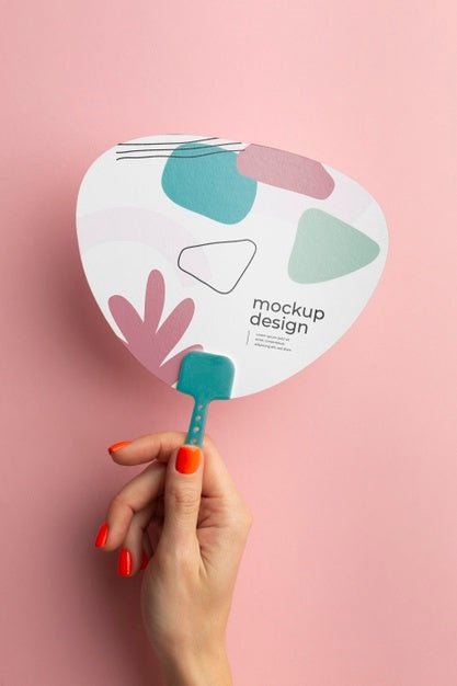 Free Top View Of Female Hands Holding Mock-Up Paper Fan Psd