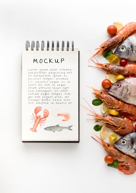 Free Top View Of Fish With Shrimp And Notebook Psd