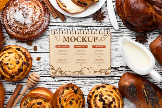 Free Top View Of Notebook With Assortment Of Pastries Psd