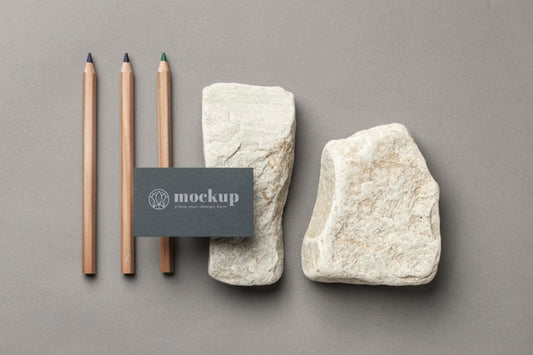 Free Top View Of Paper Stationery With Stones And Pencils Psd