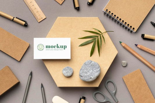 Free Top View Of Paper Stationery With Stones, Leaf And Pencils Psd