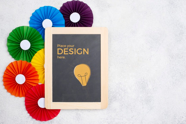 Free Top View Of Rainbow Colored Rosettes And Blackboard Psd