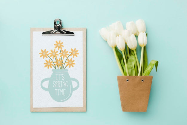 Free Top View Of White Tulips And Notepad Psd