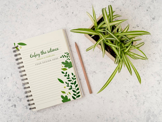 Free Top View Plant Surrounded By Notepad With Mock-Up Psd