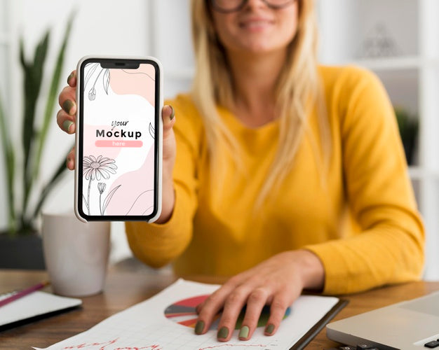 Free Woman At Desk Showing Phone Mock-Up Psd