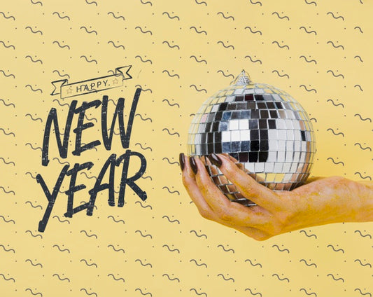 Free Woman Holding Disco Ball With New Year Lettering Psd