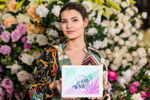 Free Woman Holding Tablet Mockup For Spring Sale Psd
