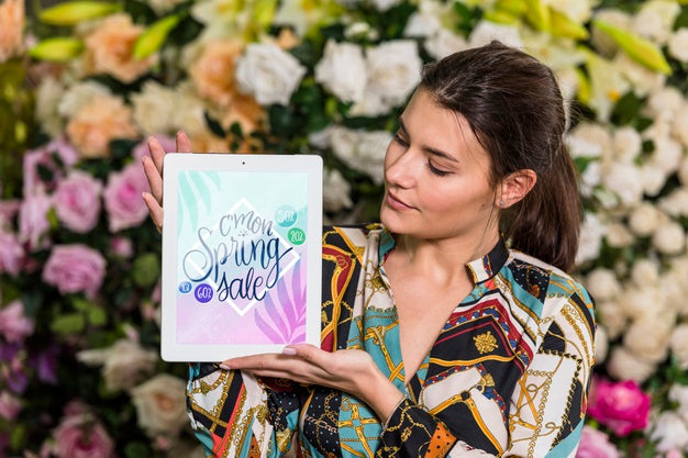 Free Woman Holding Tablet Mockup For Spring Sale Psd