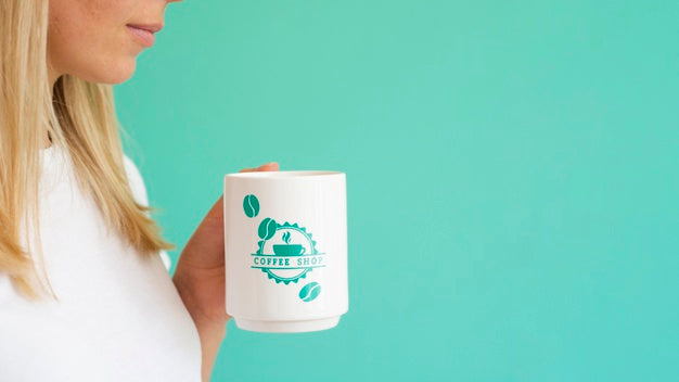 Free Woman Holding Up A White Coffee Mug With Copy Space Psd