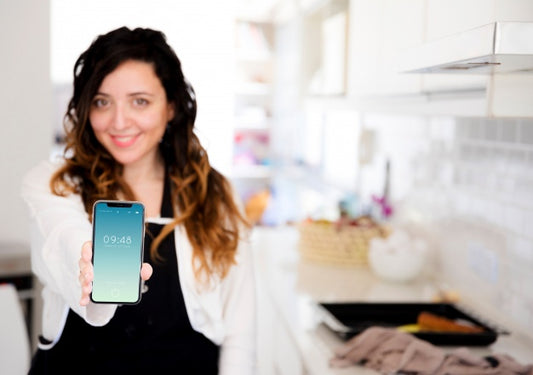 Free Woman In Kitchen Presenting Smartphone Mockup Psd