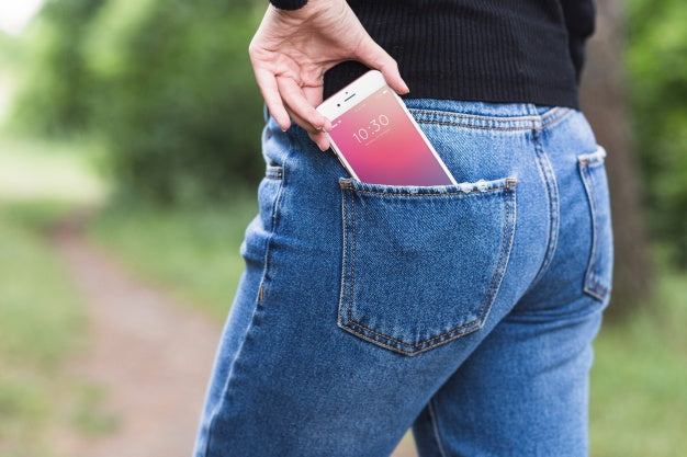 Free Woman In Nature With Smartphone In Pocket Psd