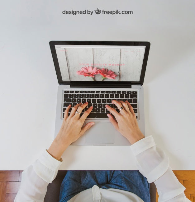 Free Woman Typing On Laptop Sitting At White Table Psd