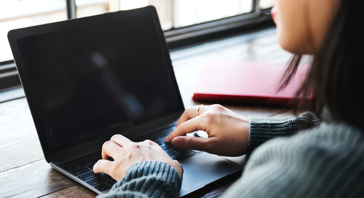 Free Woman Using A Laptop With An Empty Screen