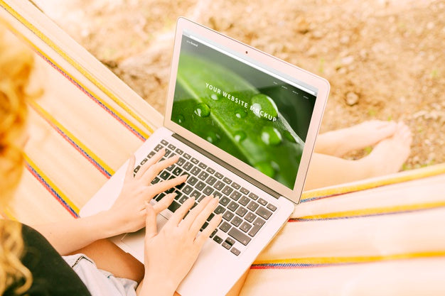 Free Woman Using Laptop Mockup In Nature Psd