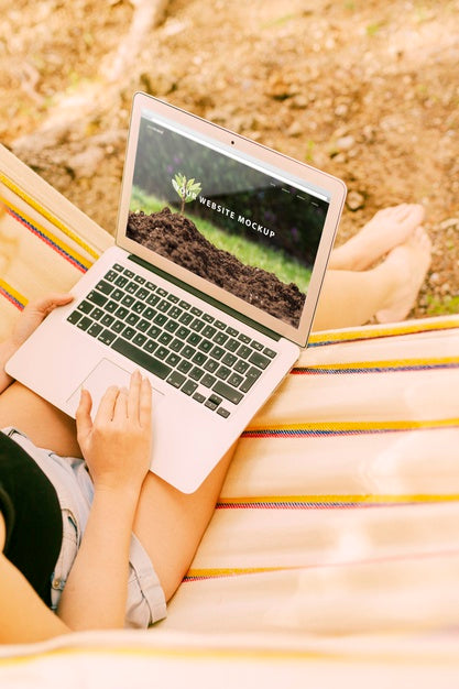 Free Woman Using Laptop Mockup In Nature Psd