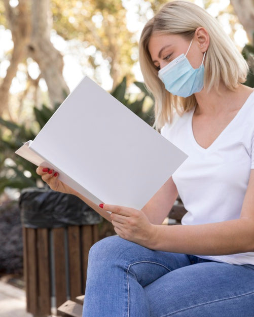 Free Woman With Mask On Street Reading Book Psd