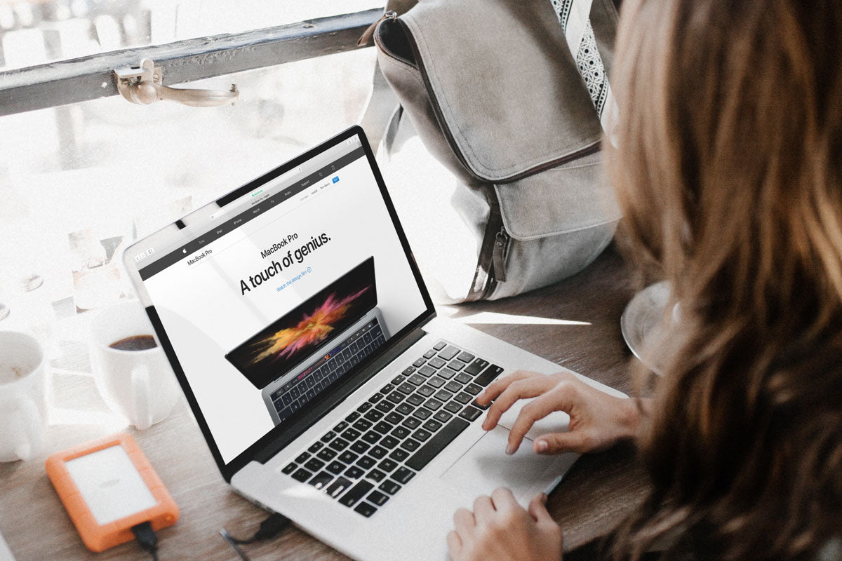 Free Young Woman Working On Her New Macbook Pro PSD Mockup