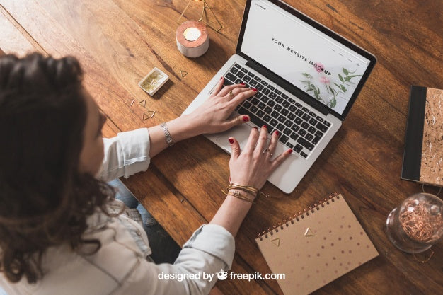 Free Woman Working With Laptop On Wooden Table Psd