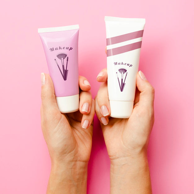 Free Women Holding Up Hand Cream Bottles Mock-Up Psd