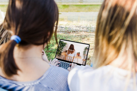 Free Women Looking At Tablet Mockup In Park Psd