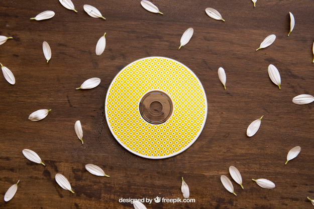 Free Yellow Cd Mockup With Petals Psd