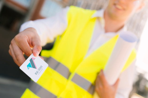 Free Young Architect Holding A Business Card Mock-Up Psd