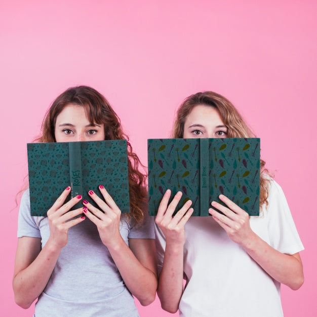 Free Young Girls Holding Book Cover Mockup Psd