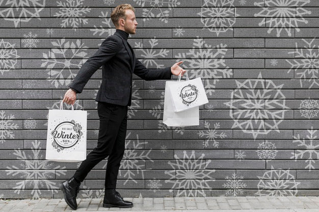 Free Young Man Walking With Shopping Bags Psd